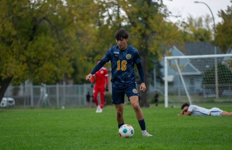 Keaston Brooker playing soccer for Brandon University.