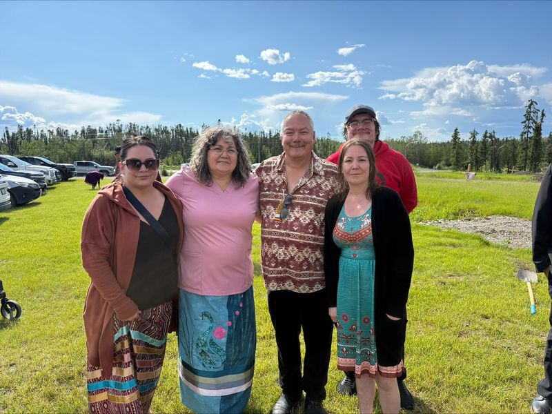 Felix Walker with family and community members at an outdoor gathering in Nelson House.