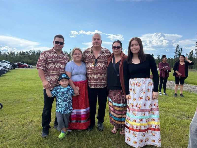 Felix Walker with a multi-generational family group at a community event.