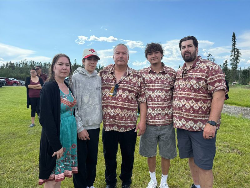 Felix Walker with family members, several in matching shirts, at a community gathering.